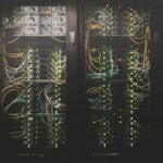 Сървърни шкафове с мрежови кабели — илюстративна снимка, не обект на Anthropic. / Server racks with network cables — illustrative photo, not an Anthropic facility.
