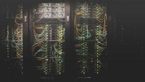 Сървърни шкафове с мрежови кабели — илюстративна снимка, не обект на Anthropic. / Server racks with network cables — illustrative photo, not an Anthropic facility.