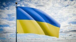 Ukrainian national flag against the sky; illustrative image, not a photo of the prisoner exchange