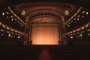 Empty theatre auditorium with stage and seating; illustrative image, not the production The Divine Comedy in Veliko Tarnovo. Photo: Liam McGarry / Unsplash