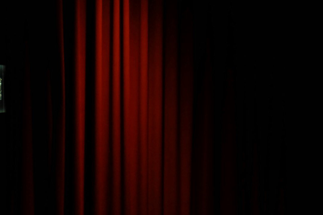 Red theatre curtains — illustrative photograph, not from the production in Veliko Tarnovo. Vanessa Zhu / Unsplash